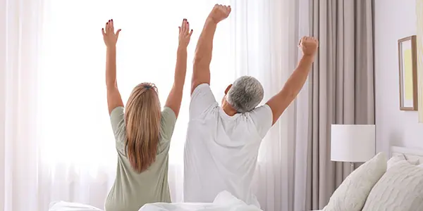 couple stretching in bed